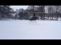 Two helicopters landing in snow at Bibury Court Hotel, Gloucestershire